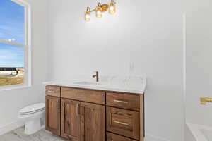 Full bath featuring vanity and toilet