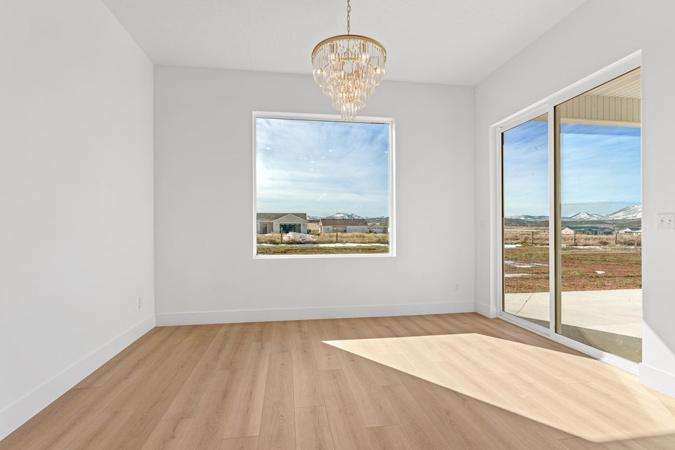 Unfurnished dining area featuring a chandelier and light wood-type flooring