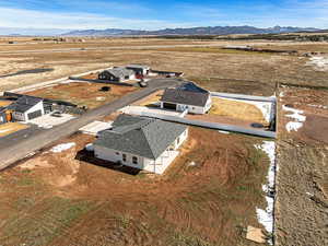 Overview of rural landscape featuring mountains and nearby suburban area