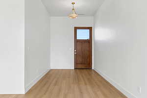 Entrance foyer featuring light wood-style floors and baseboards