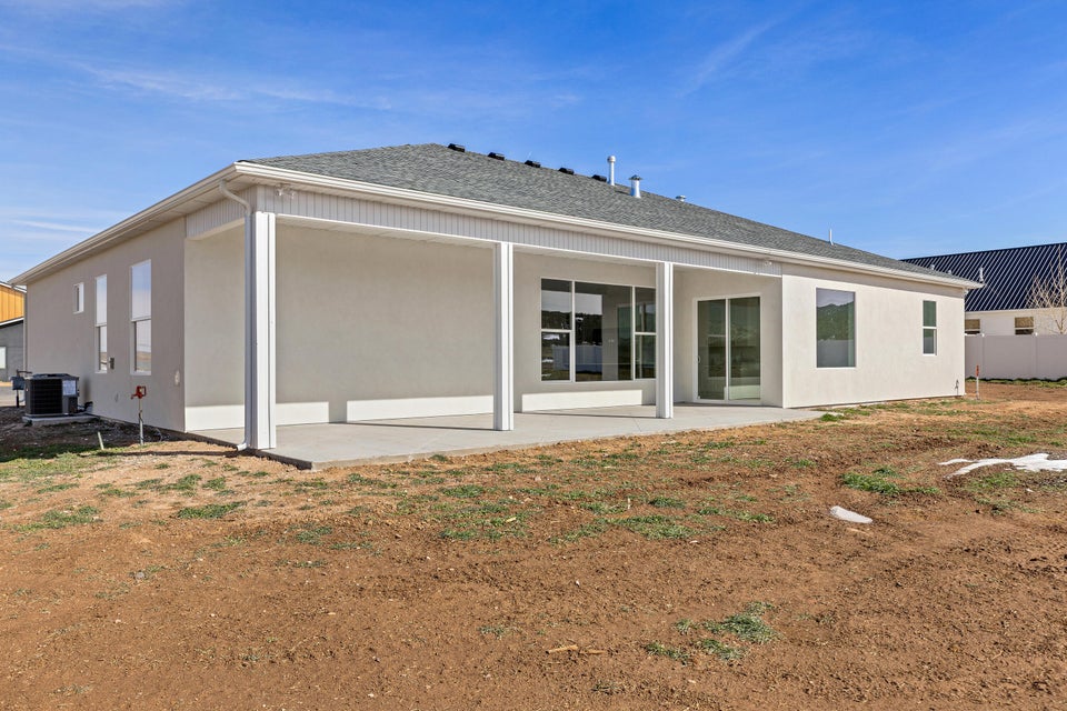 Rear view of property with a patio and a shingled roof