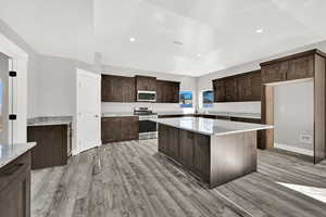 Beautiful wood cabinets with granite countertops and gas range.