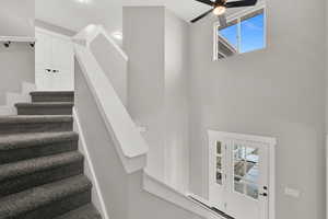 Vaulted foyer with a lots of light and staircase to upper level.