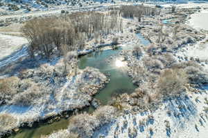 Snowy aerial view with a water view