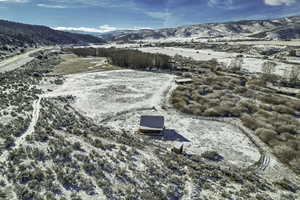 Snowy aerial view featuring a mountain view