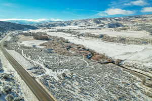 Snowy aerial view featuring a mountain view