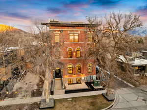 Italianate house with solar panels, a mountain view, and brick siding