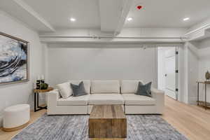 Living area featuring light wood finished floors and recessed lighting