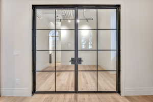 Detailed view of wood finished floors and french doors