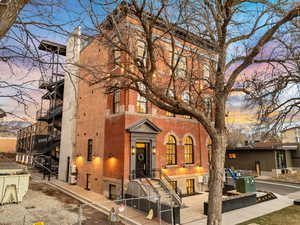 Rear view of property featuring a gate, brick siding, and a fenced front yard