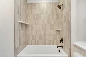 Bathroom with tub / shower combination and toilet