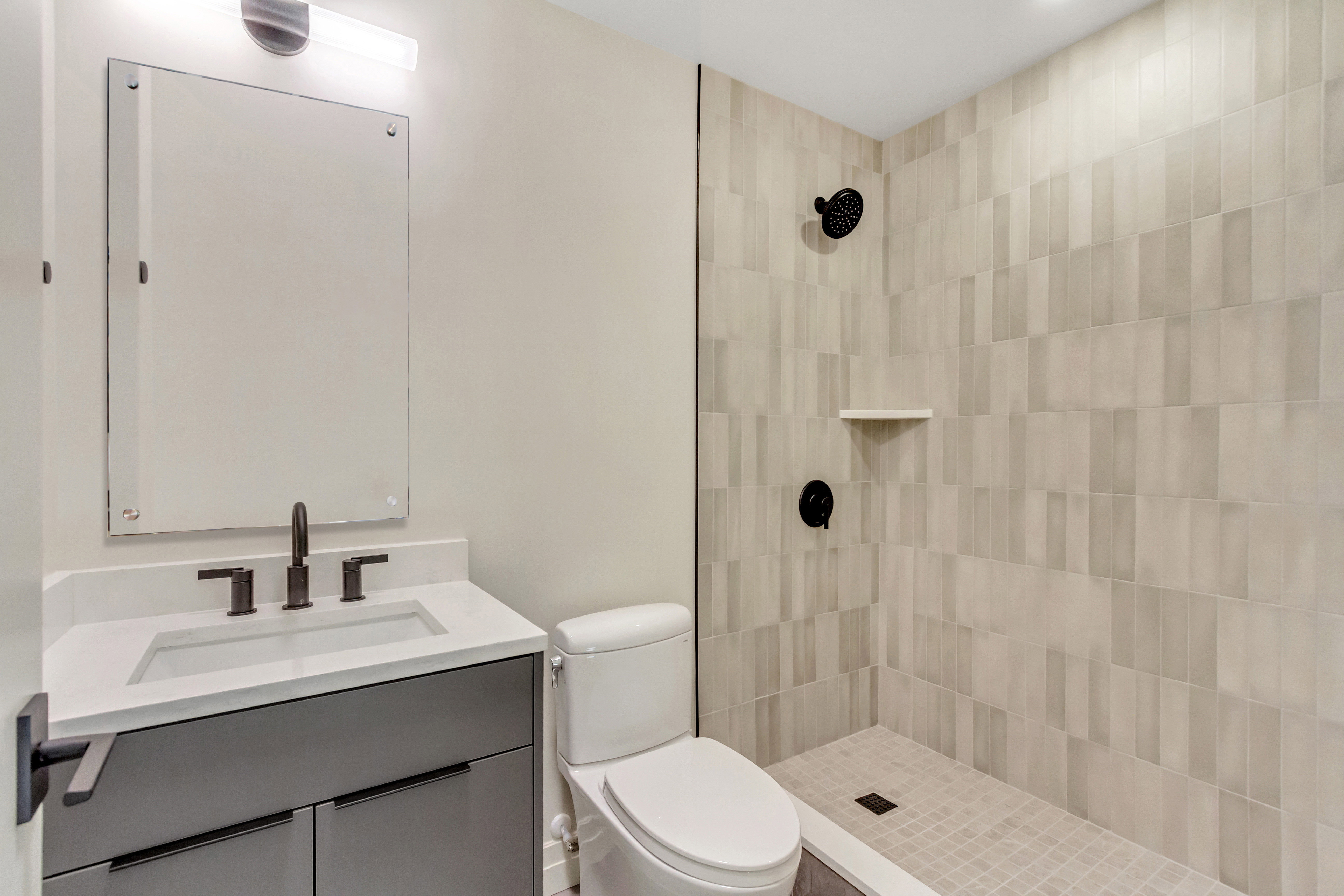 Bathroom with vanity and a tile shower