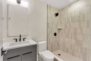Bathroom with vanity and a tile shower
