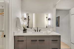Bathroom featuring vanity and light wood-style floors