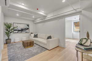 Living room featuring light wood-type flooring and recessed lighting