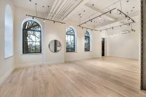 Spare room with rail lighting and light wood finished floors