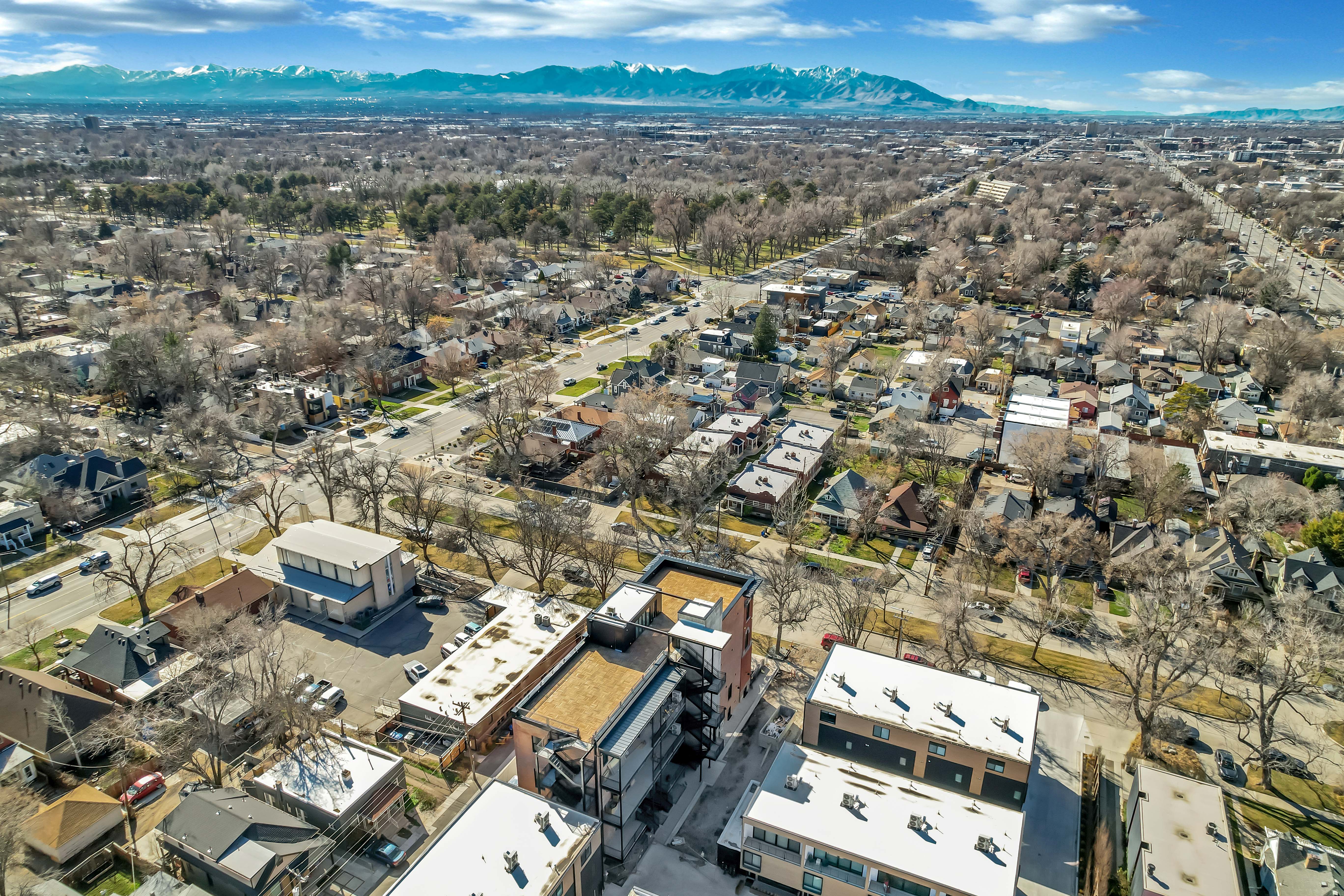 Aerial perspective of suburban area with a mountainous background