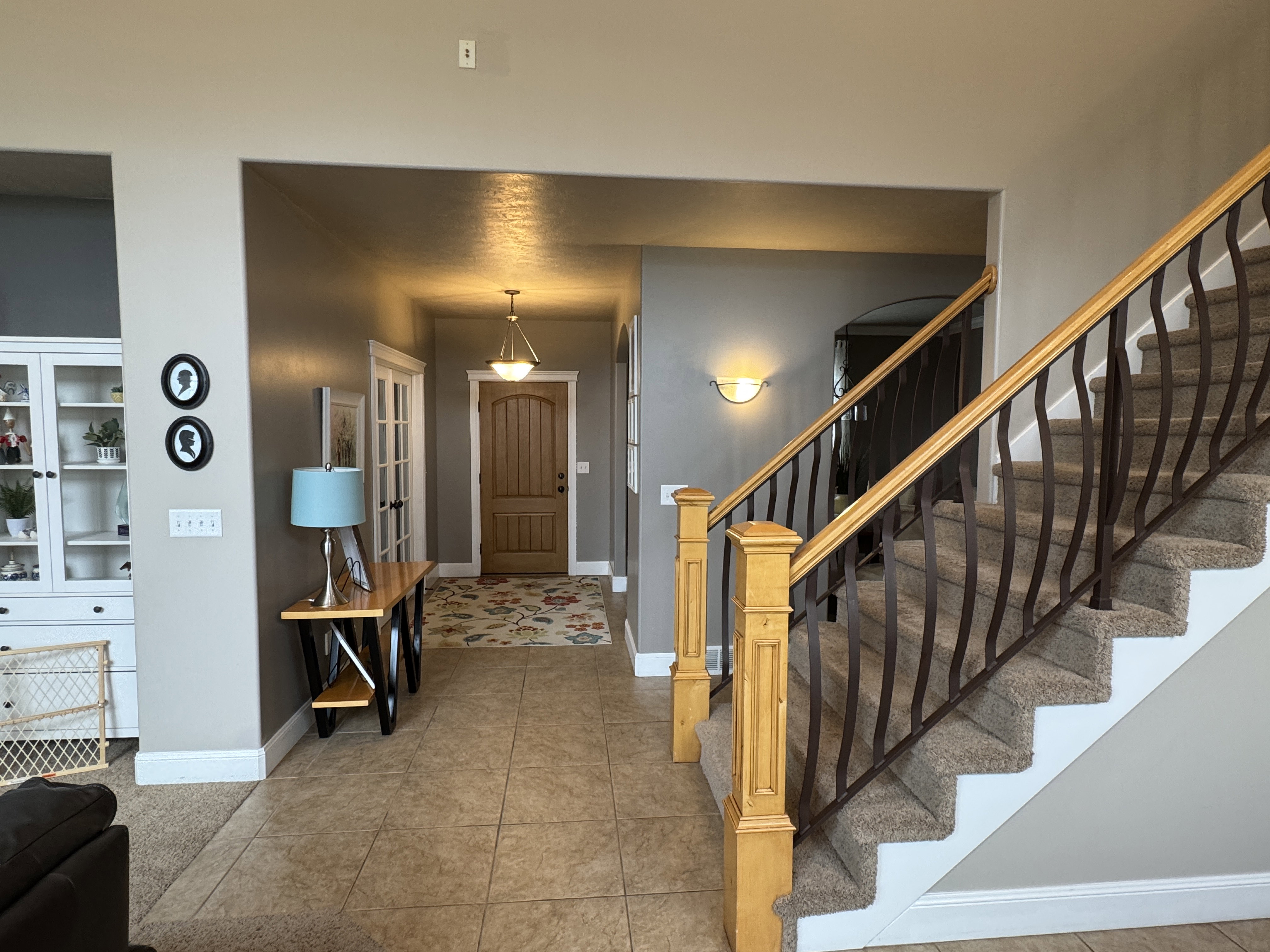 Entryway featuring stairway and light tile patterned floors