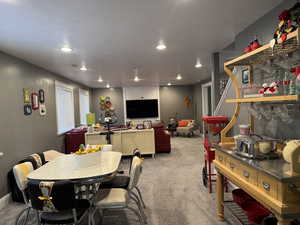 Carpeted dining space featuring recessed lighting