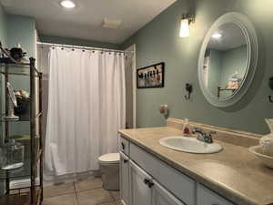 Full bathroom featuring vanity, light tile patterned flooring, and recessed lighting