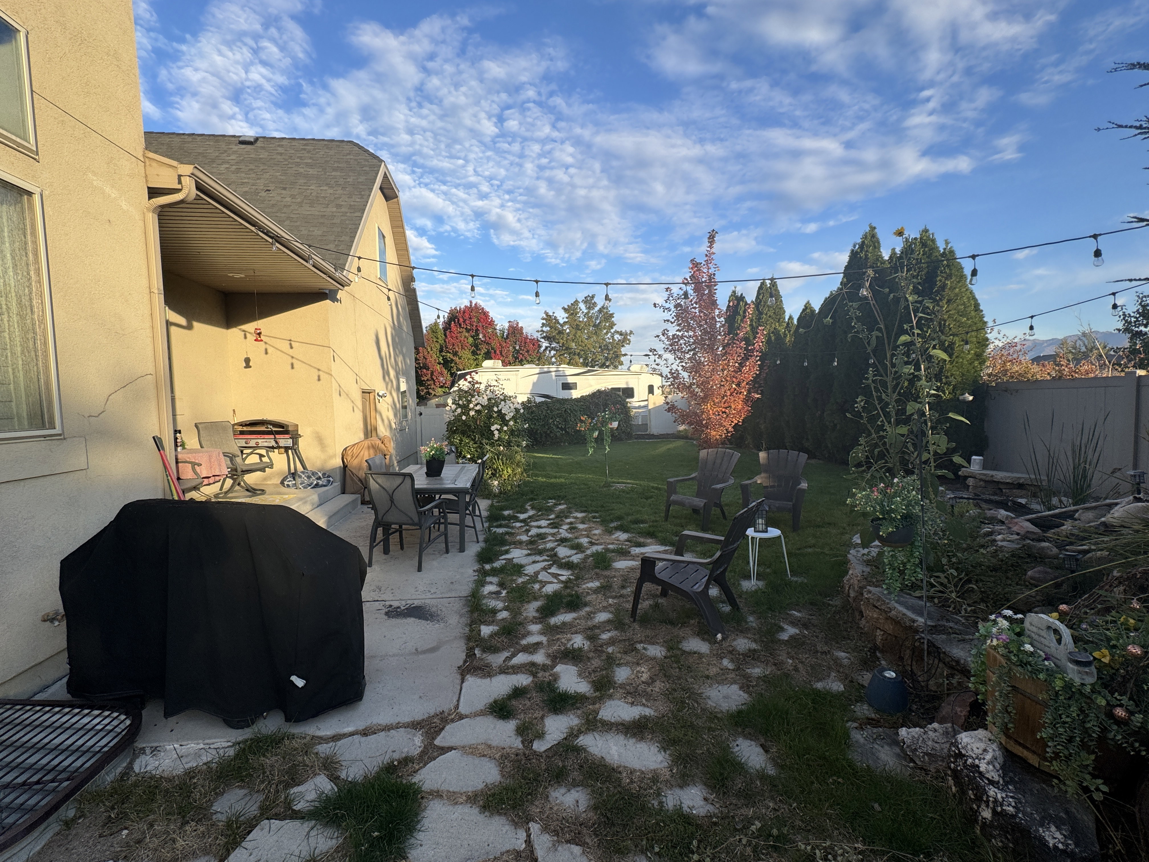 Fenced backyard with a patio area, area for grilling, and outdoor dining space