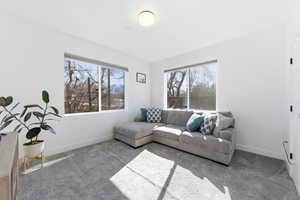 Carpeted living area with baseboards