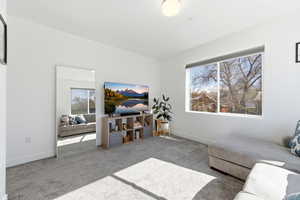 Sitting room featuring carpet floors and baseboards