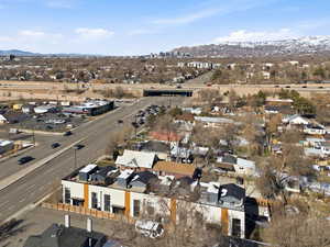 Aerial overview of property's location featuring a mountainous background and nearby suburban area
