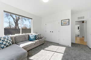 Carpeted living area featuring baseboards