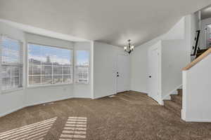 Entryway with living area space. New carpet