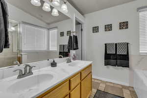 Master bathroom with a garden tub, double vanity, a stall shower.