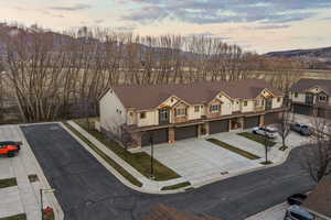 Beautiful tree lined backyard with stream, large driveway