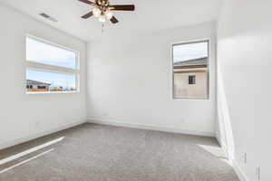 Spare room featuring ceiling fan and light carpet