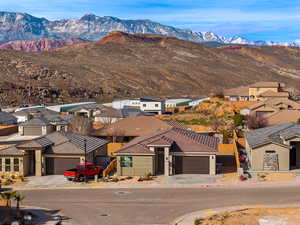 View of mountain backdrop featuring nearby suburban area