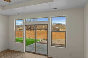Doorway to outside with wood finished floors and a mountain view