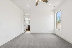 Empty room with a ceiling fan, light colored carpet, and recessed lighting