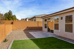 Fenced backyard with a patio area