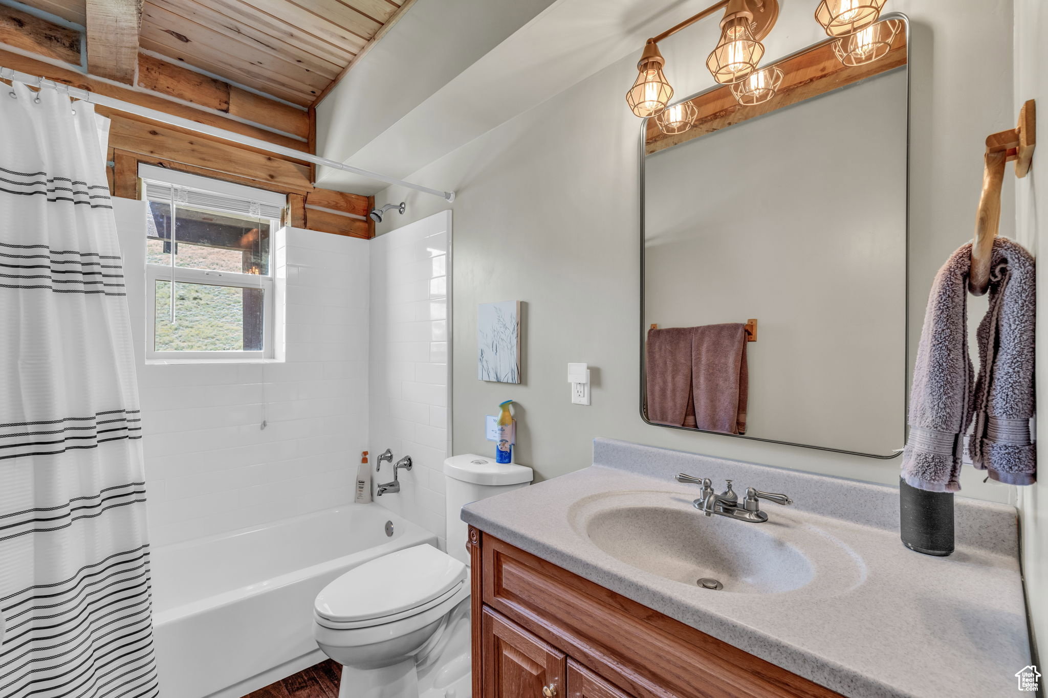 Bathroom featuring vanity, shower / tub combo, and wooden ceiling