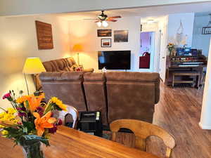 Living room with wood finished floors and ceiling fan