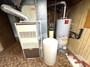 Utility room with gas water heater and heating unit