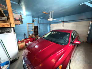 Garage with concrete block wall and a garage door opener