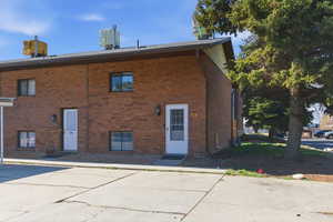 View of building exterior with uncovered parking