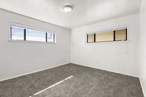 Bedroom 2 featuring dark carpet and baseboards