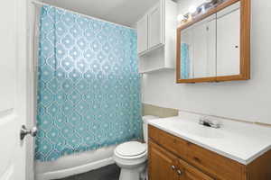 Full bath with vanity and shower / bath combo with shower curtain