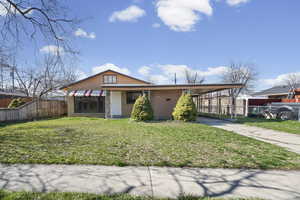 View of front of house featuring a carport, brick siding, concrete driveway, and covered porch