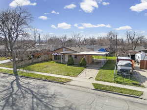 View of front facade with an attached carport and driveway