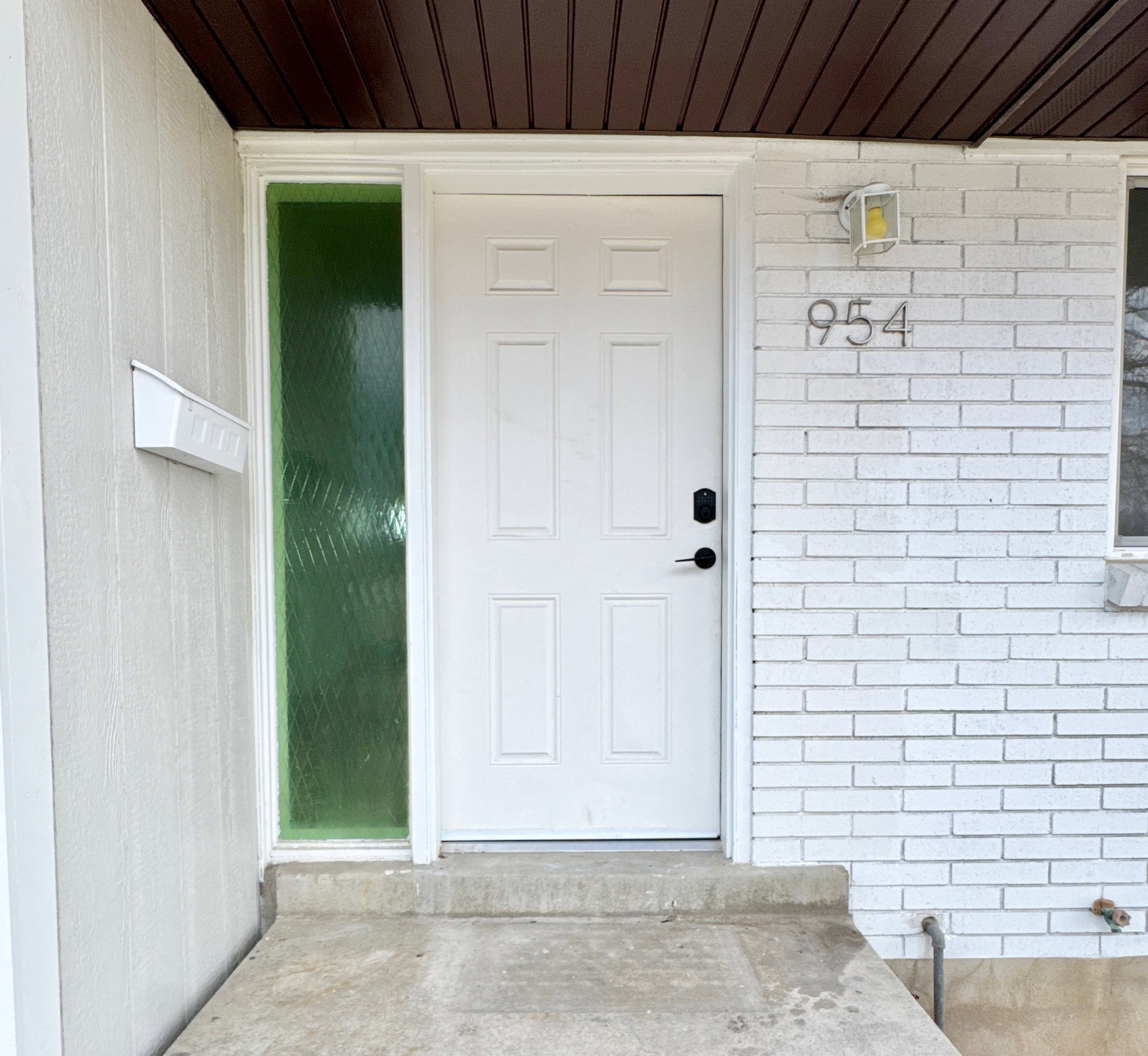 Entrance to property with brick siding