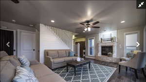 Living area featuring ceiling fan, recessed lighting, dark wood finished floors, and a tiled fireplace