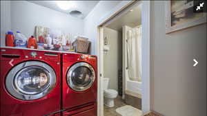 Laundry room featuring washing machine and dryer and light tile patterned flooring
