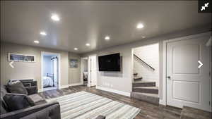 Living area featuring recessed lighting and dark wood finished floors